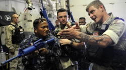 100623-N-1635S-325SULU SEA  (June 23, 2010) - Fire Controlman 2nd Class Nicholas Omeara teaches room entry techniques to members of the Philippine Coast Guard (PCG) aboard the guided-missile destroyer USS Chung-Hoon (DDG 93) during Maritime Interdiction Operation (MIO) training off the coast of Cagayan de Oro, Philippines. Chung-Hoon, PCG search and rescue vessel BRP Romblon (SAR 3503), and representatives from Coast Guard District Northern Mindanao are conducting MIO training to increase the PCG's capability to help keep coastal areas safe and prevent terrorist and lawless groups from freely moving people, supplies and weapons along coastal regions and sea.  (U.S. Navy photo by Mass Communication Specialist 2nd Class (AW) Joshua Scott/RELEASED)